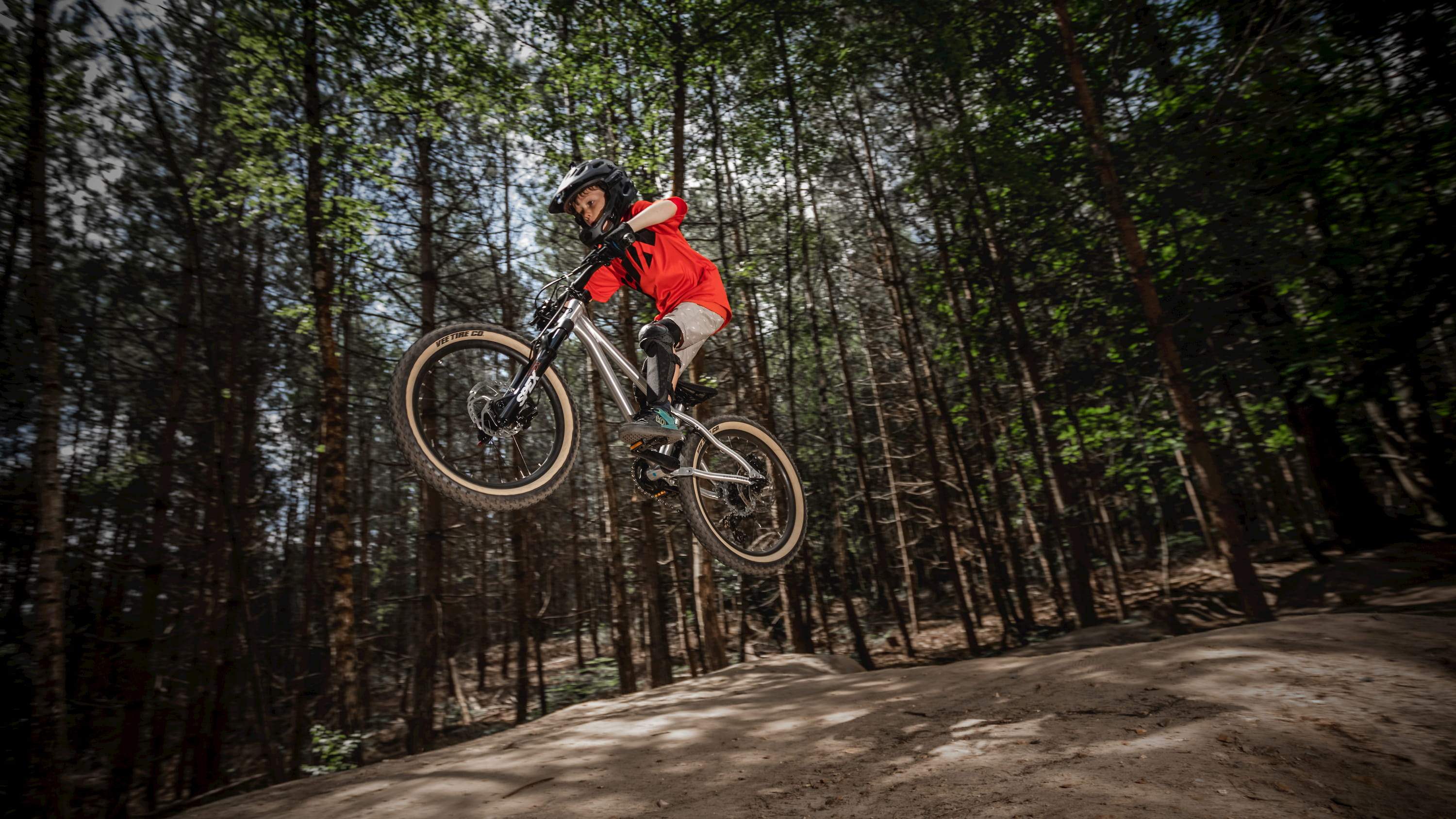 Kid performing a jump on a Hellion 20 bike